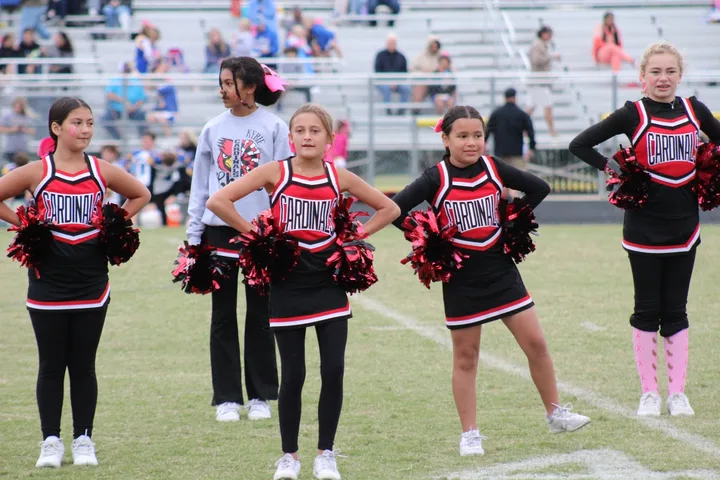 Four Oaks Cardinals cheerleaders on the sideline