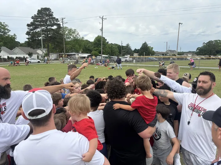 Four Oaks coaches and players on the sideline