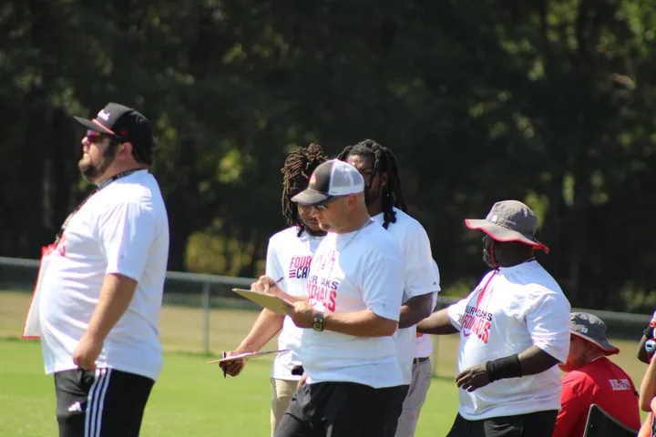 Four Oaks coaches and players on the sideline