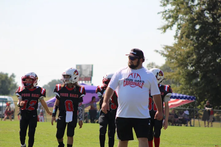 Four Oaks coaches and players on the sideline