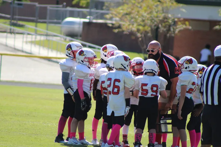 Four Oaks coaches and players on the sideline