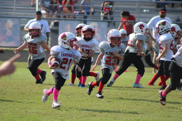 Young Four Oaks players running with the ball