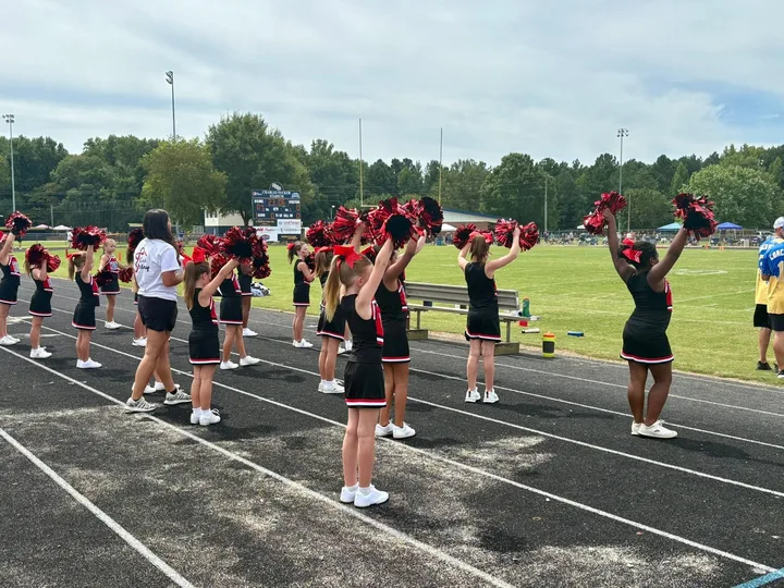 Four Oaks Cardinals cheerleaders on the sideline
