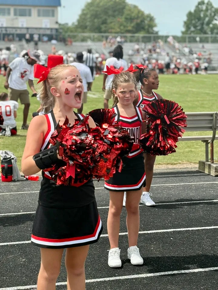 Four Oaks Cardinals cheerleaders on the sideline