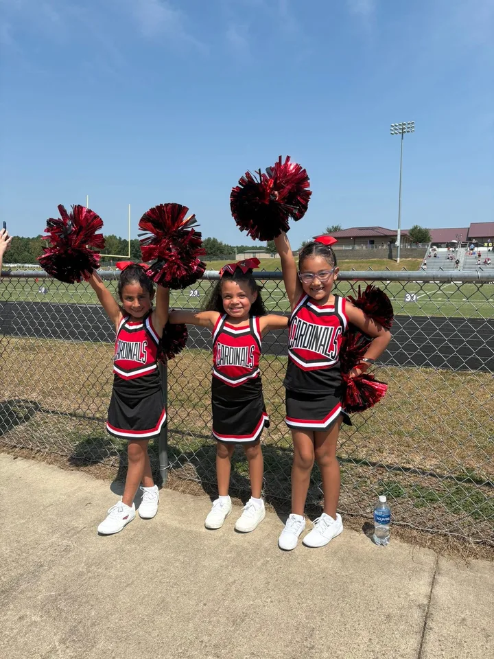 Four Oaks Cardinals cheerleaders on the sideline