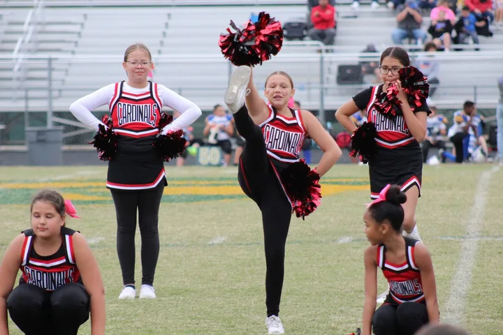 Four Oaks Cardinals cheerleaders on the sideline