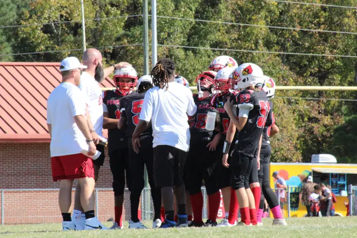 Four Oaks coaches and players on the sideline