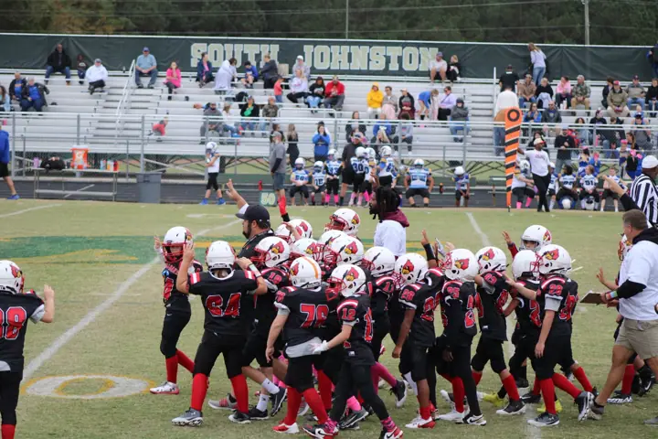 Four Oaks players taking the field on game day
